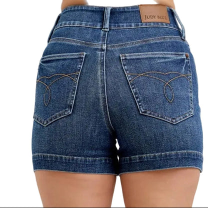 Denim shorts worn by a person on a white background