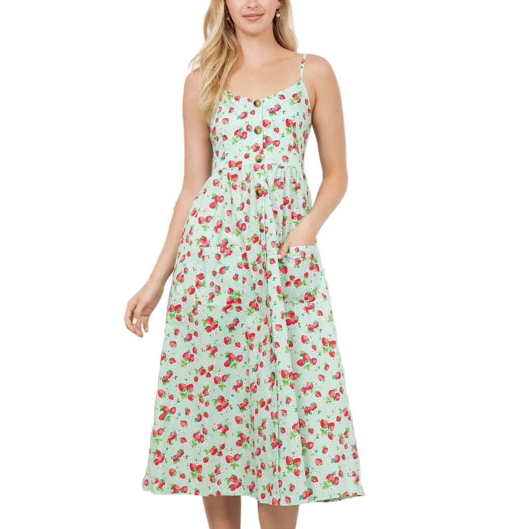 Woman wearing a floral dress standing in a room with plants.