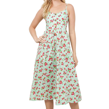 Woman wearing a floral dress standing in a room with plants.