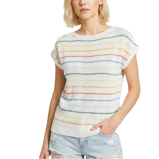 Woman wearing a colorful striped sweater and denim shorts on a white background