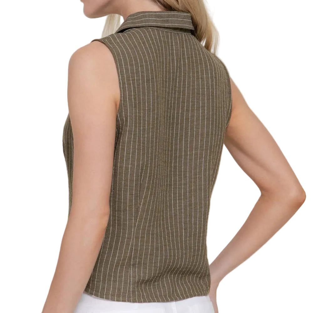 Woman wearing a sleeveless brown pinstripe top against a plain background