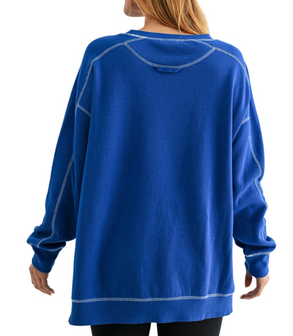 Person wearing a blue sweatshirt with a plain background