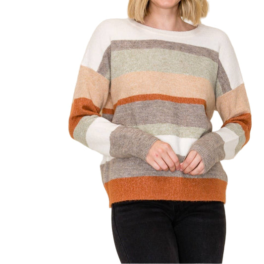 Woman wearing a striped sweater with a plain background