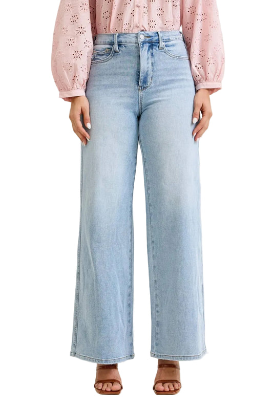 Light blue jeans worn by a person on a beige background