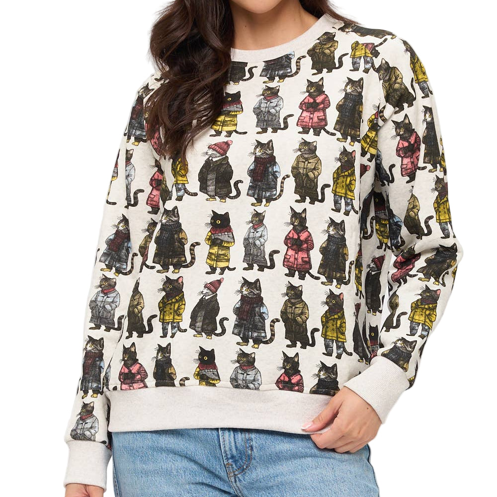 Woman wearing a sweater with cat pattern against a white background