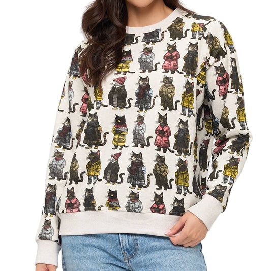 Woman wearing a sweater with cat pattern against a white background