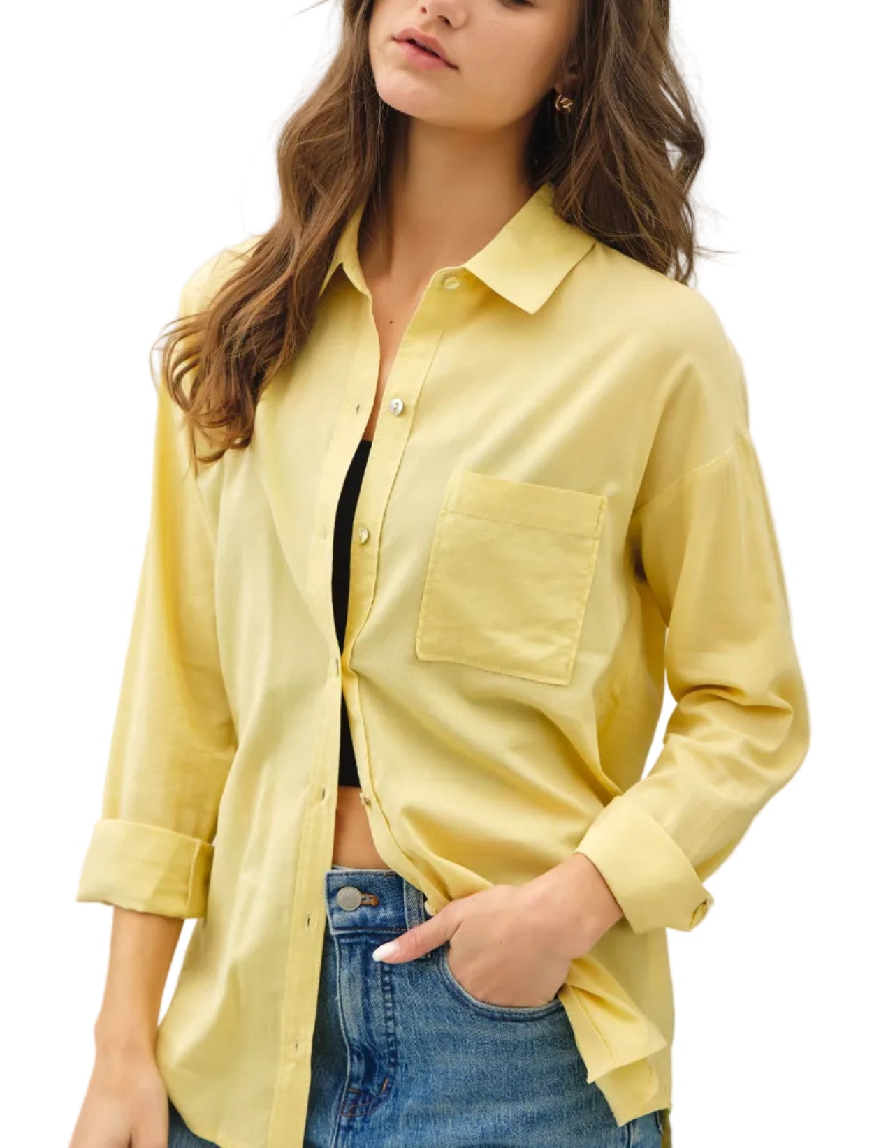 Woman wearing a light yellow shirt with a white background
