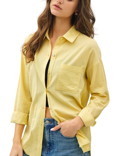 Woman wearing a light yellow shirt with a white background