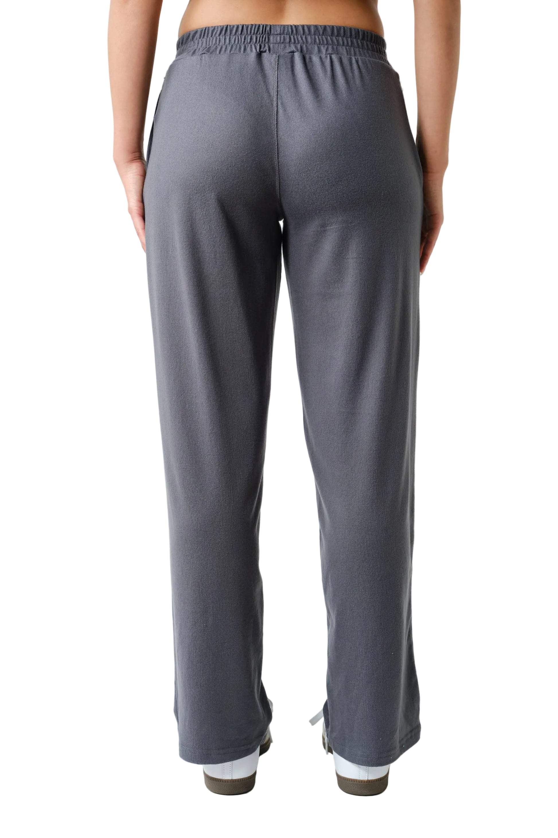 Person wearing gray pants on a white background