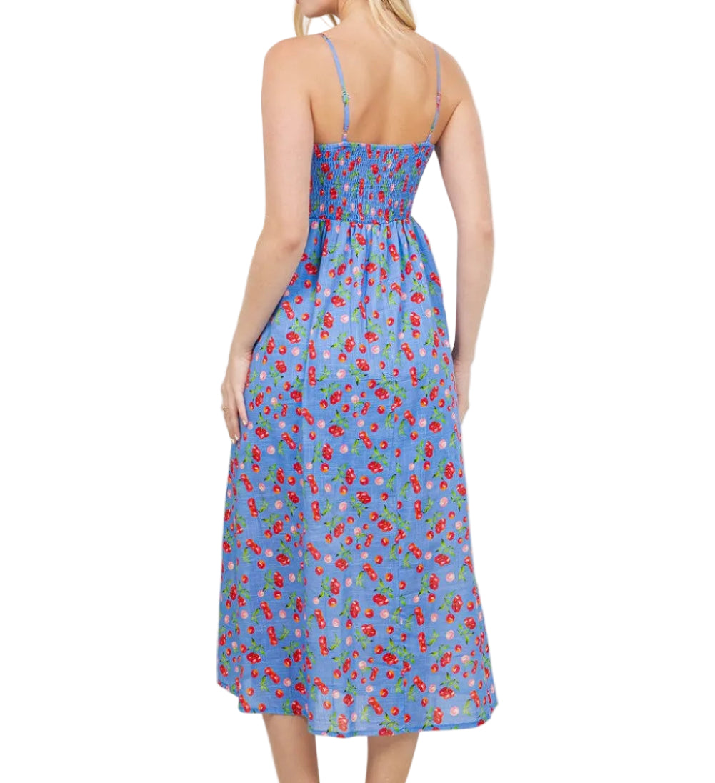 Woman wearing a blue floral dress in a room with plants