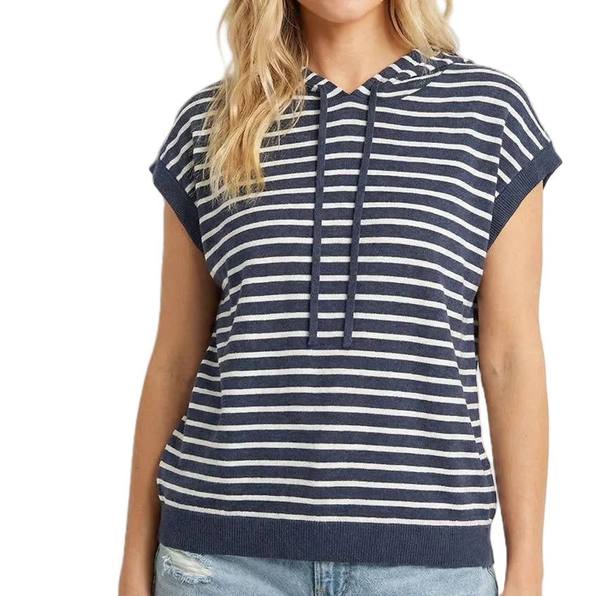 Woman wearing a navy and white striped hoodie with a plain background