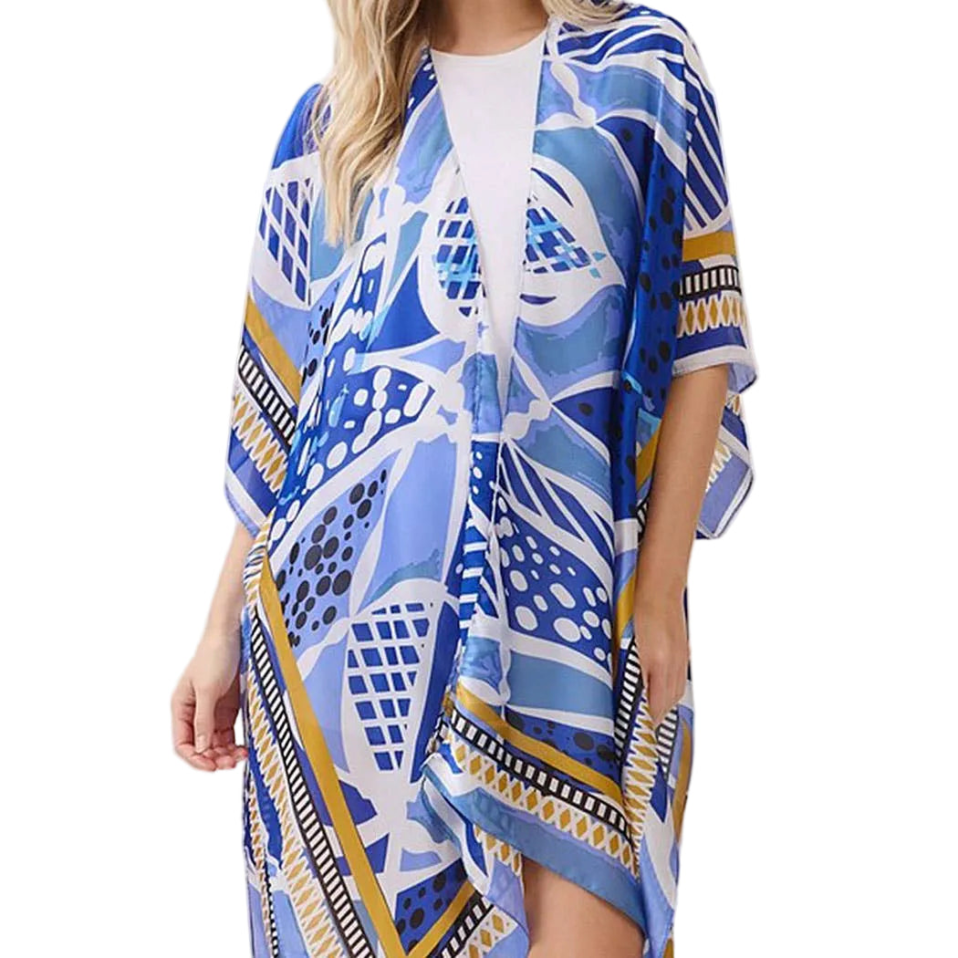 Woman wearing a blue patterned kimono-style garment on a white background