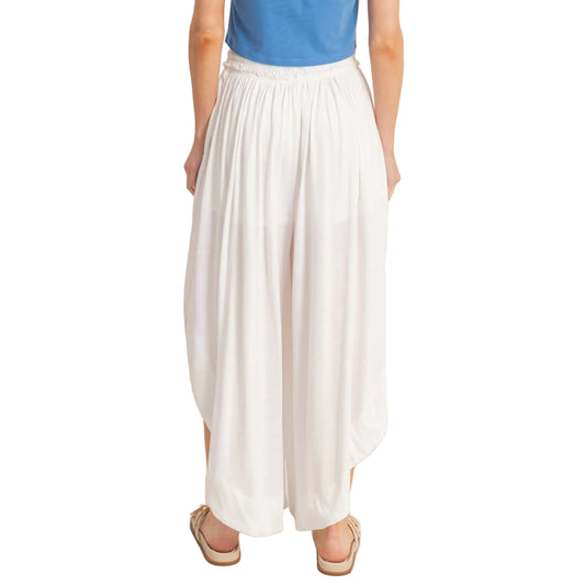 Person wearing a blue top and white skirt on a plain background