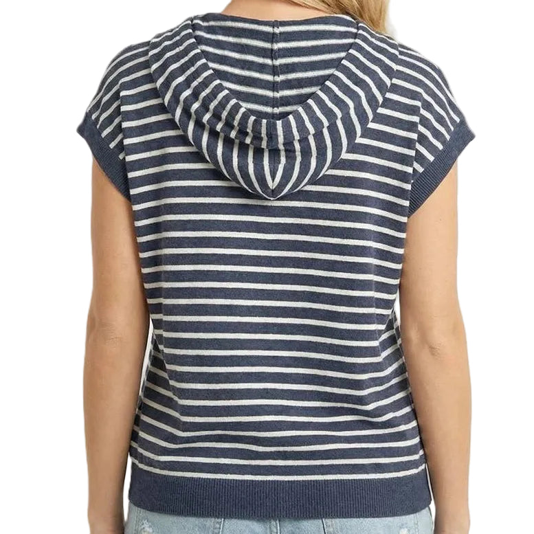 Woman wearing a navy and white striped sleeveless hoodie on a beige background