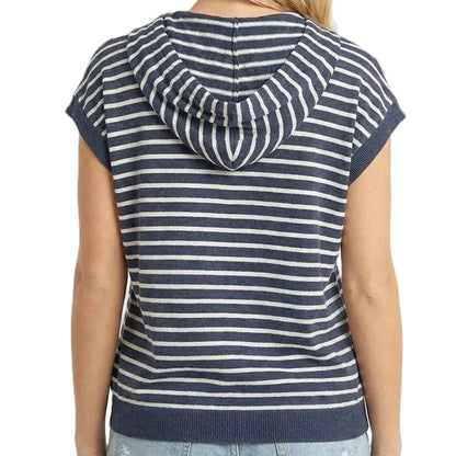 Woman wearing a navy and white striped sleeveless hoodie on a beige background