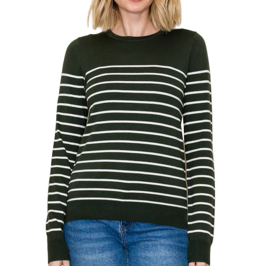 A woman wearing a forest green and white striped sweater against a plain background