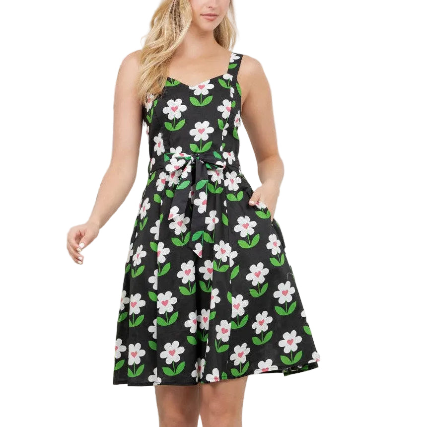 Woman wearing a floral dress in a room with plants