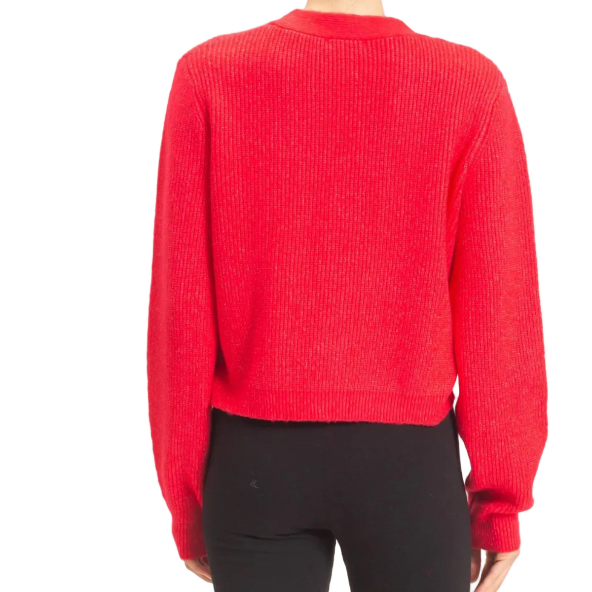 A woman viewed from the back wearing a bright red ribbed knit cropped sweater and black pants, standing against a plain light background.