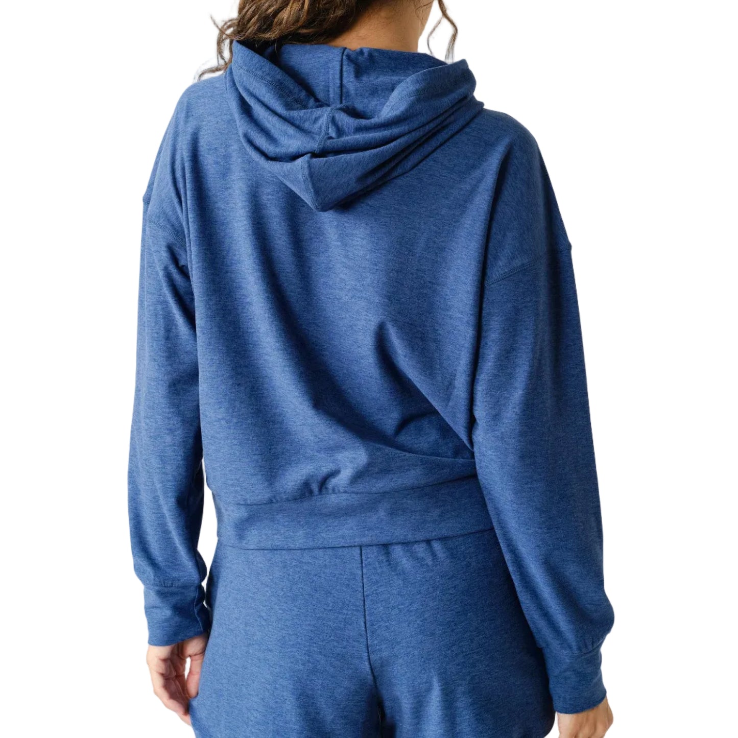 Person wearing a blue hoodie and shorts set on a white background