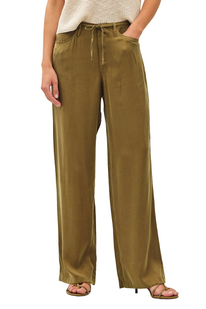 Person wearing olive green wide-leg pants on a white background