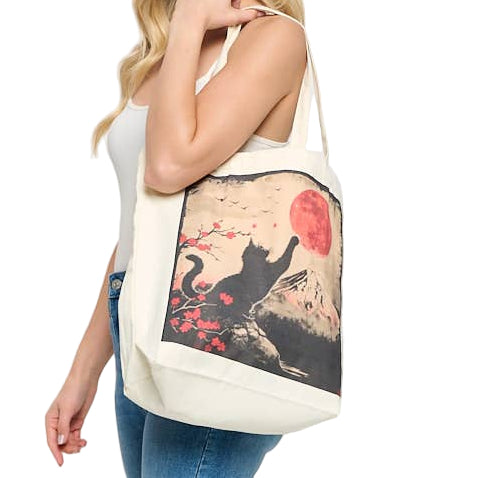 Woman holding a tote bag with a cat design on a plain background
