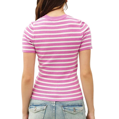 Person wearing a pink and white striped shirt and light blue jeans on a plain background