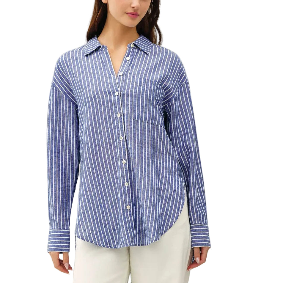 Woman wearing a blue and white striped shirt with white pants on a white background