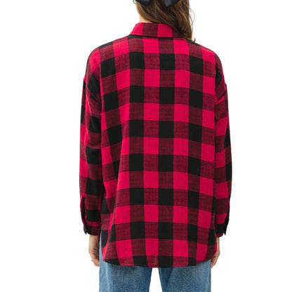 Person wearing a red and black plaid shirt and blue jeans on a white background