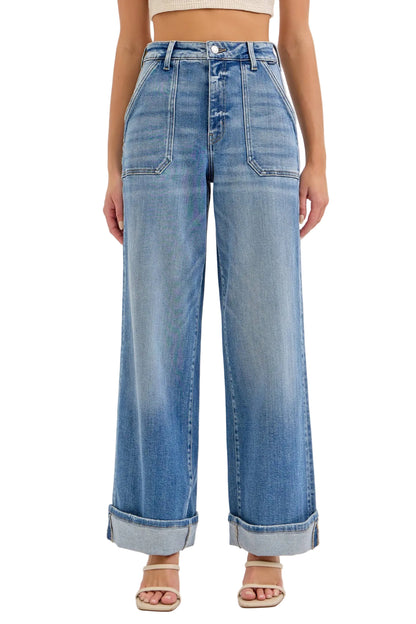 Wide-leg jeans worn by a person on a light gray background