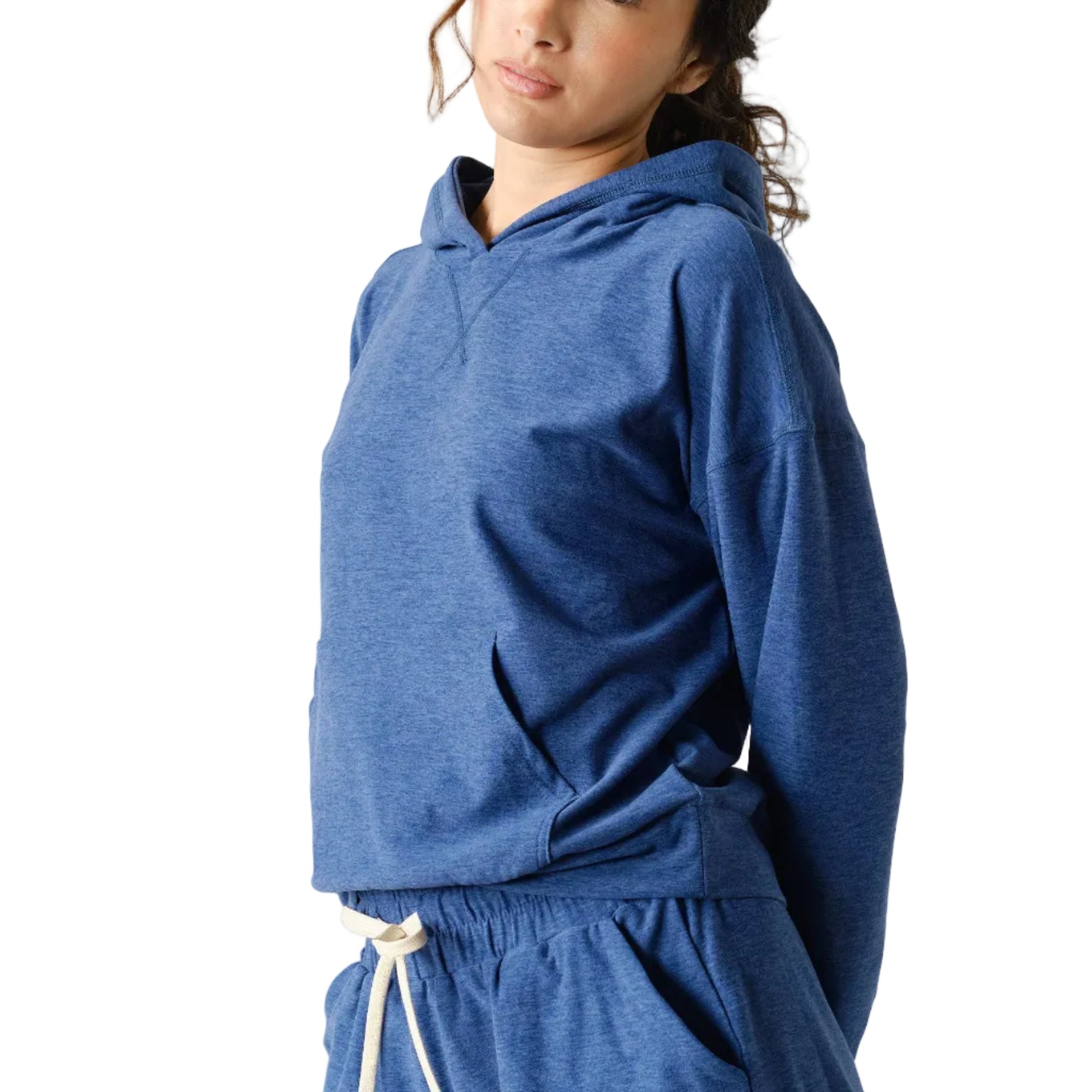 Woman wearing a blue hoodie and shorts set on a white background