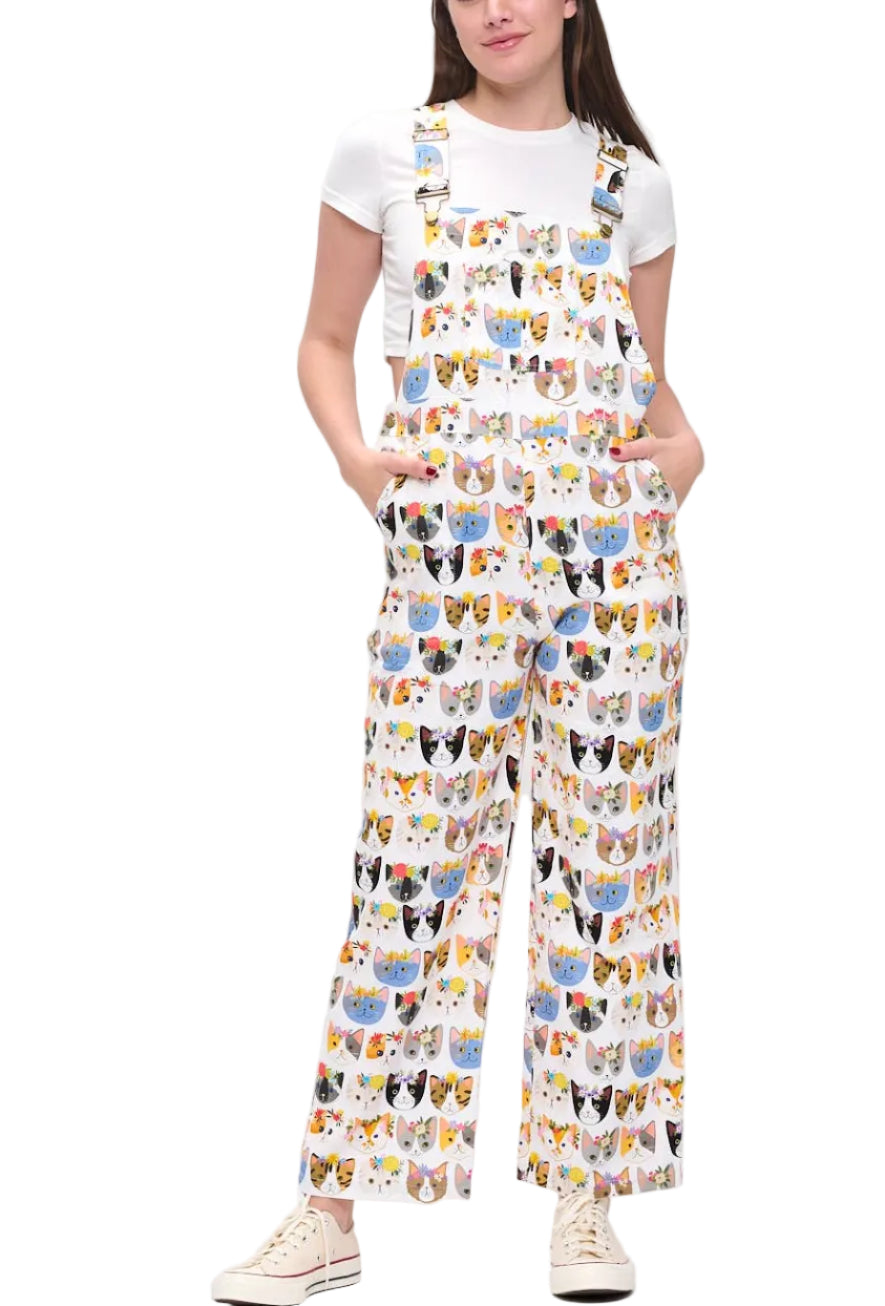 Person wearing a colorful patterned overalls on a white background