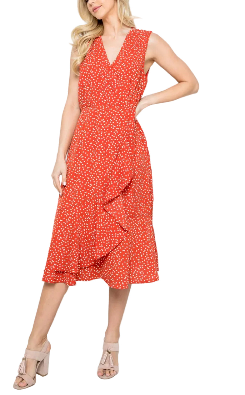 Woman wearing a red polka dot dress against a white background
