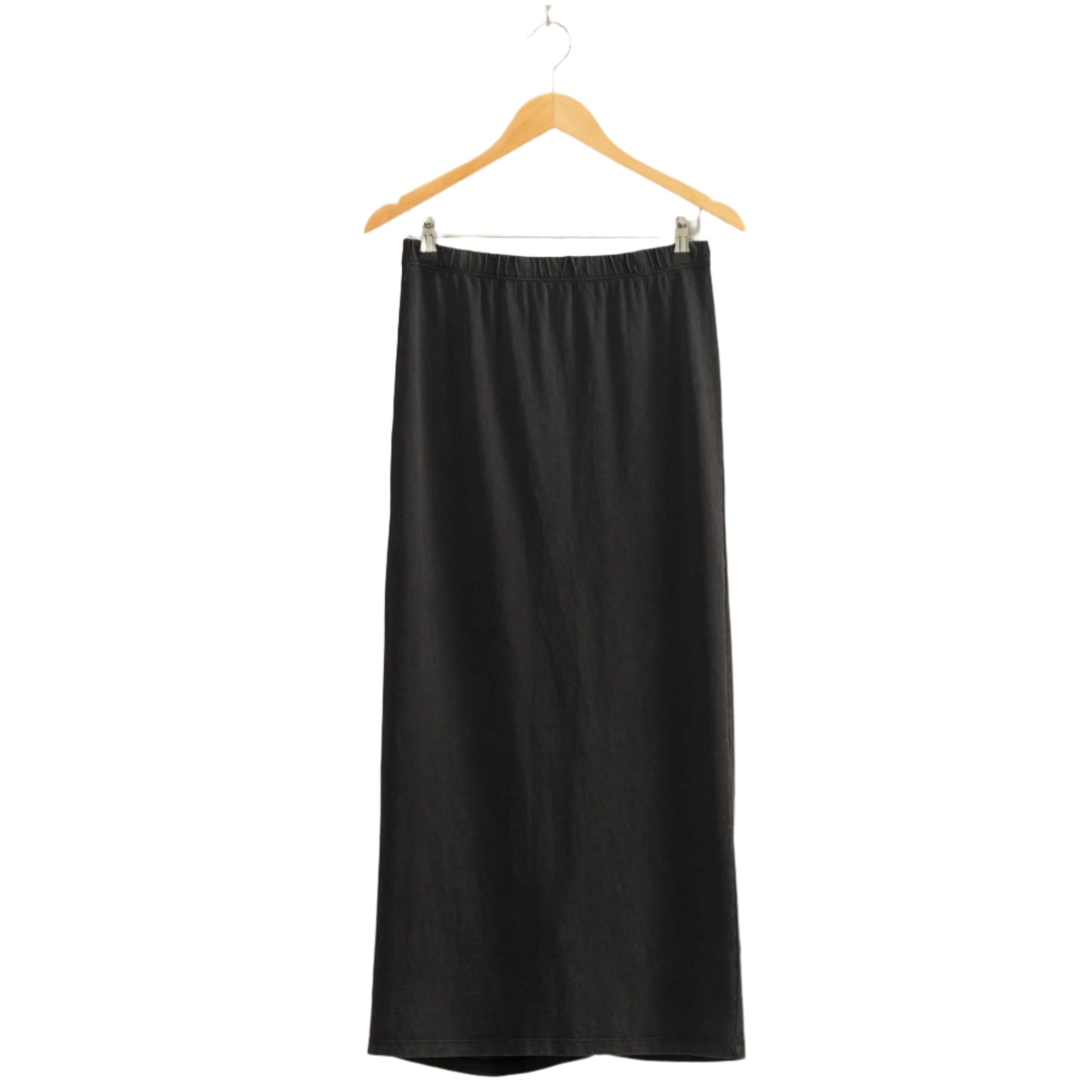 Black skirt on a wooden hanger against a beige wall