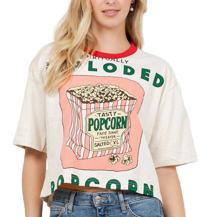 Woman wearing a graphic t-shirt with popcorn design and text.