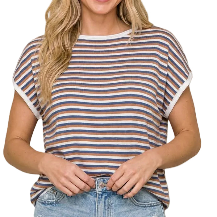 Woman wearing a striped shirt and denim shorts on a beige background