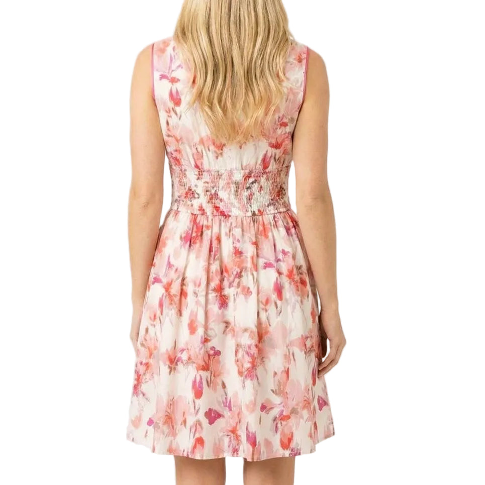 Woman wearing a floral dress on a plain background