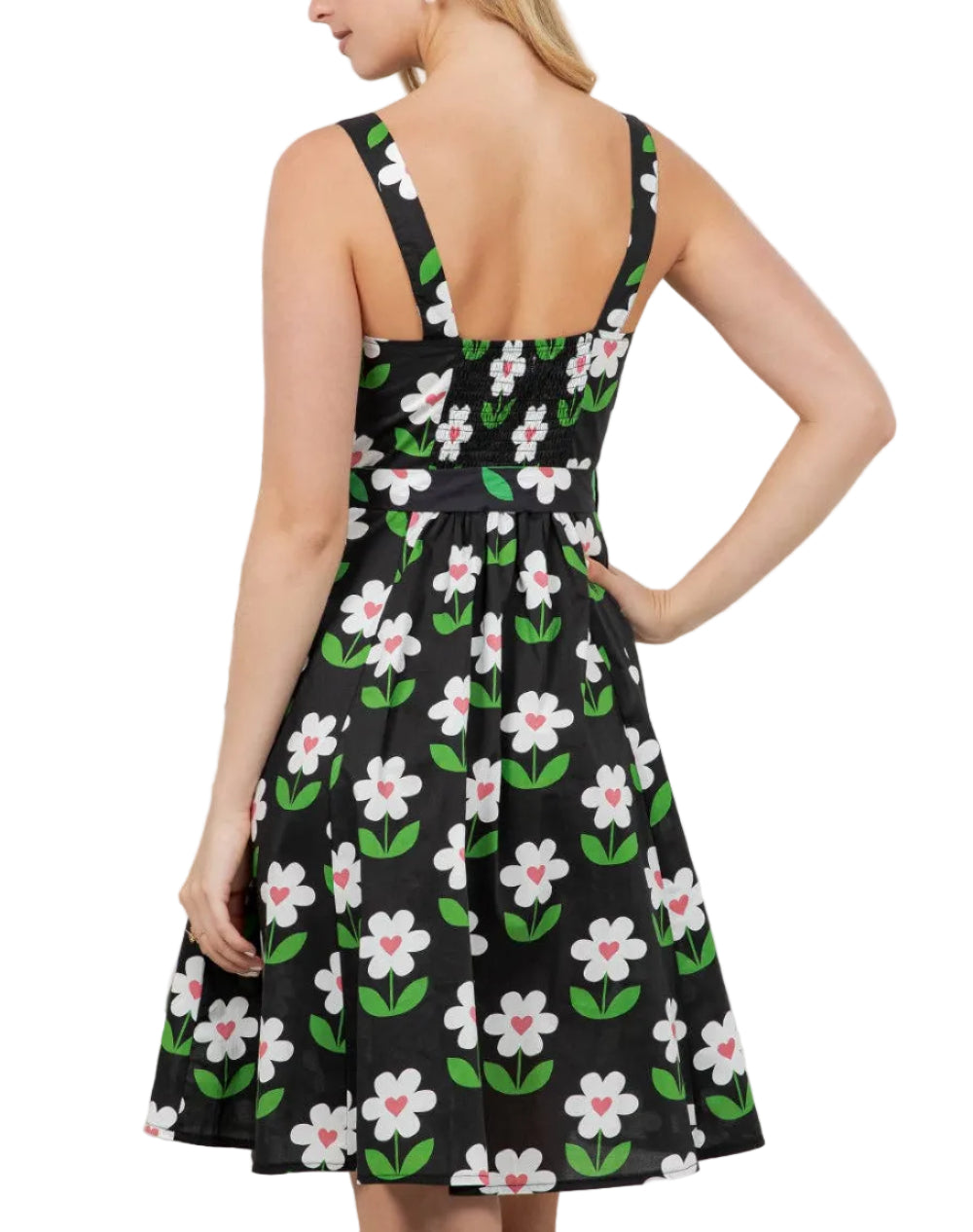 Woman wearing a black dress with floral pattern against a white background