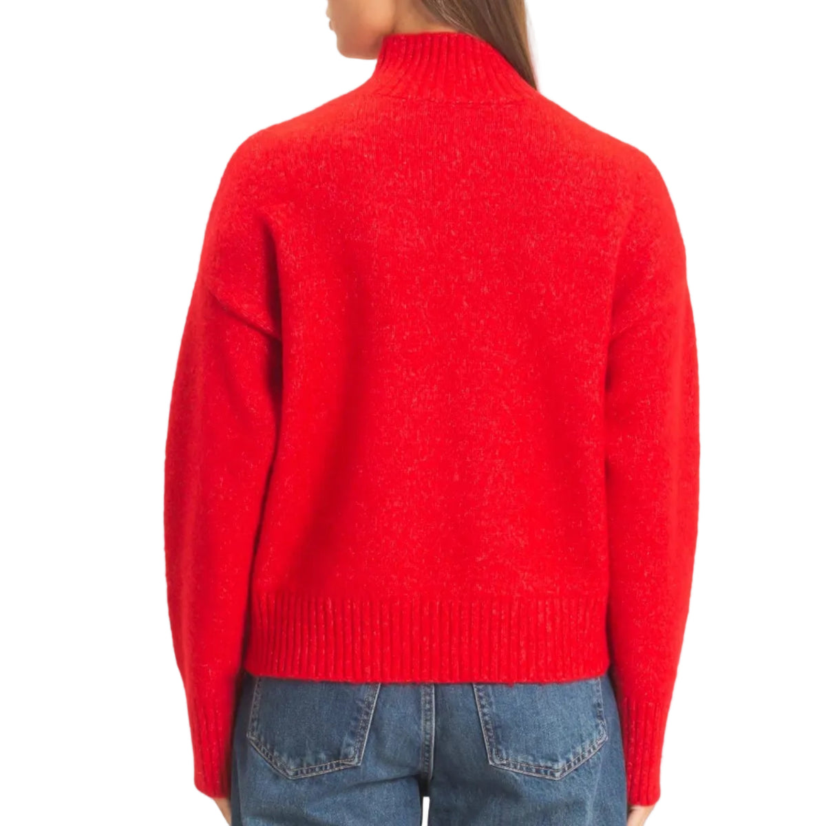 A woman shown from the back wearing a bright red knit mock-neck sweater and blue jeans against a plain light beige studio background.