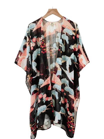 Floral kimono draped over a wooden hanger against a neutral background