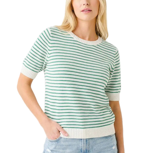 Woman wearing a green and white striped sweater with denim shorts on a white background