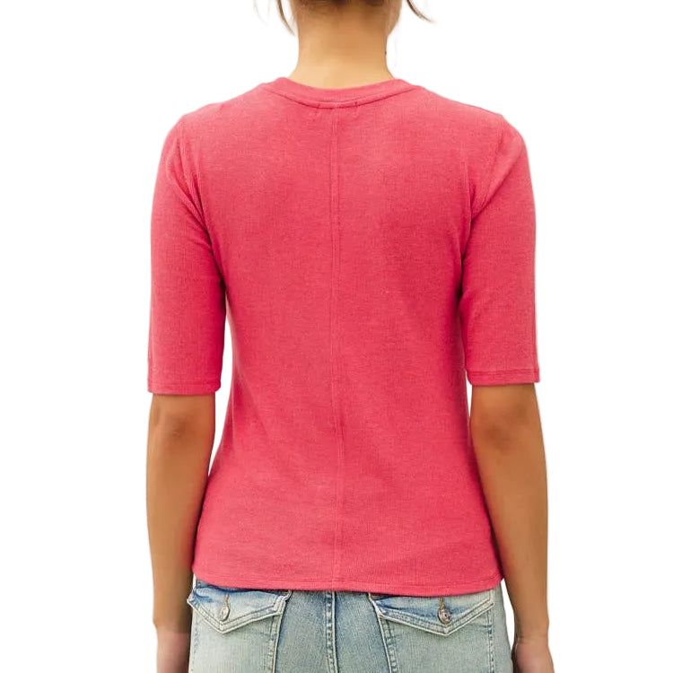 Person wearing a pink top and light blue jeans on a white background