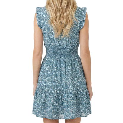 Woman wearing a blue floral dress on a white background