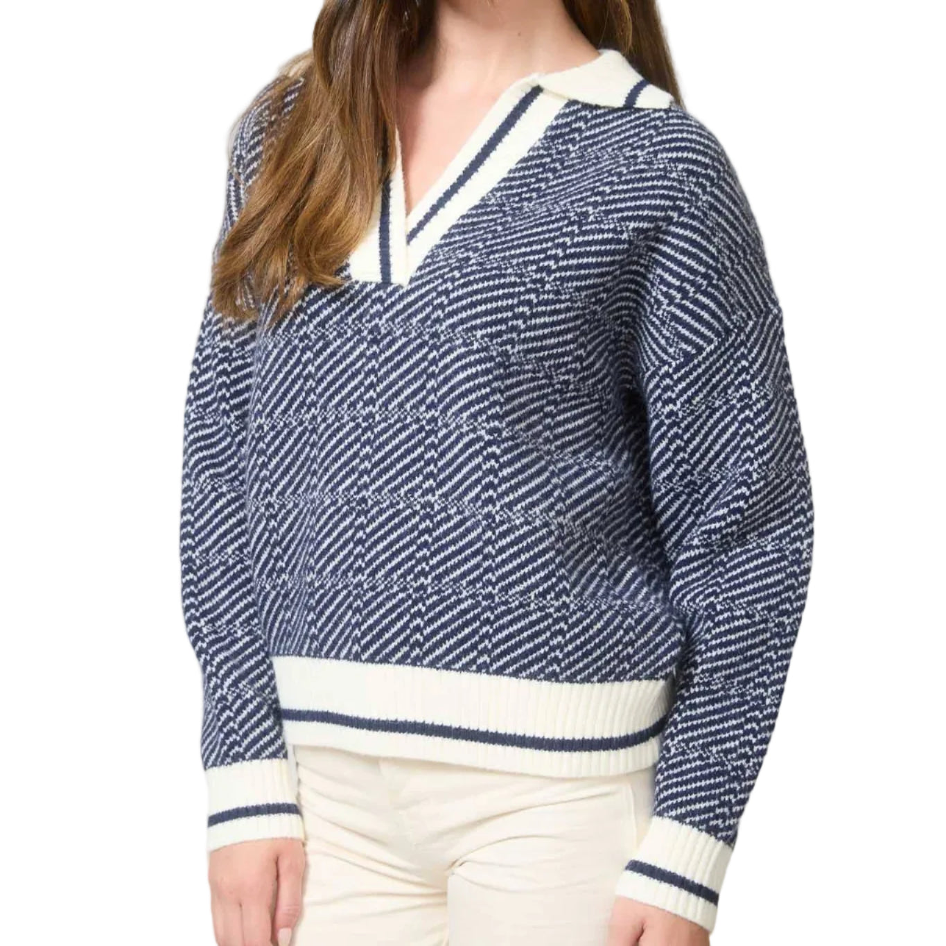 Woman wearing a blue and white patterned sweater with a V-neckline in an office setting.