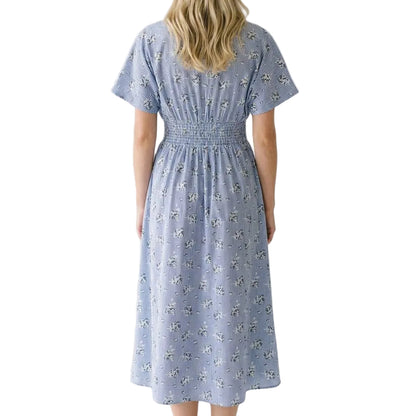 Woman wearing a blue floral dress on a white background