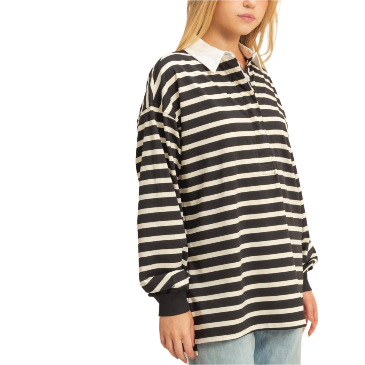 Woman wearing a black and white striped shirt with a plain background