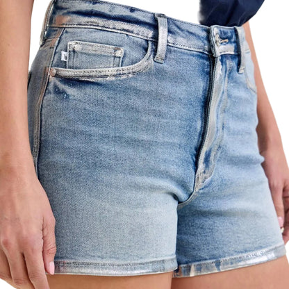Denim shorts worn by a person on a plain background