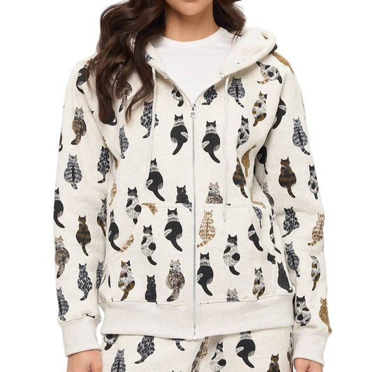 Woman wearing a white hoodie with black cat pattern on a white background