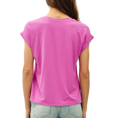 Person wearing a bright pink t-shirt and light blue jeans on a white background