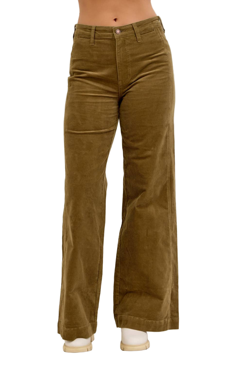 Brown corduroy pants worn by a person on a beige background
