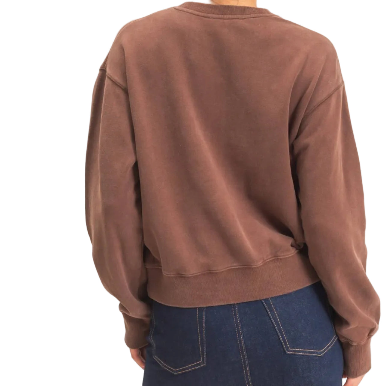 A woman shown from the back wearing a brown crewneck sweatshirt and a dark blue denim mini skirt, standing against a plain off-white background.